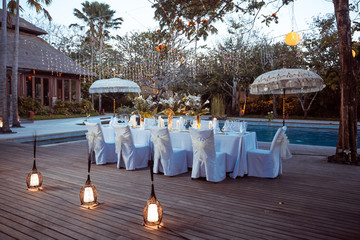 Wedding Banquet or gala dinner decorated with garlands. Festive Luxury table set up decor for wedding, party, event