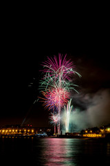 fireworks at night next to the beach