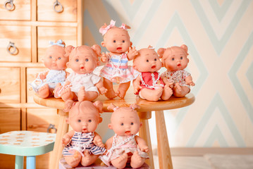 Group of cute baby dolls  on bright background