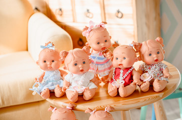 Fototapeta na wymiar Group of cute baby dolls on bright background