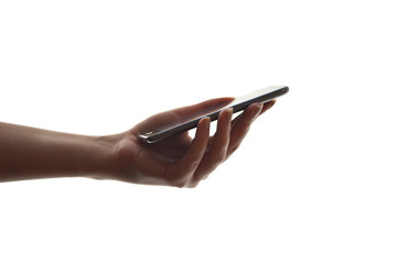 Naklejka premium The girl holds a mobile phone in her hand on a white background. Woman watching mobile screen. 