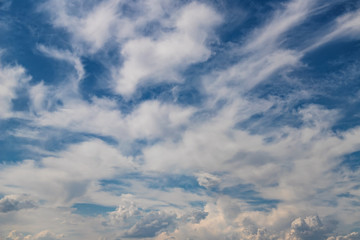 Unusual shape small fluffy clouds in the blue sky