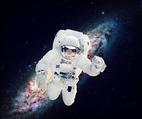 Astronaut in the outer space. Milky way on the background. Elements furnished by NASA.