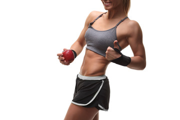 slender muscular woman holding red apple
