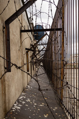 Fence and barbed wire on the roof of the building.