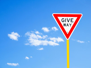 Give way sign on blue sky background