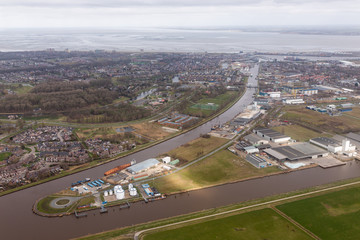 Fototapeta na wymiar Aerial view Dutch residential area Delfzijl with channel and harbor