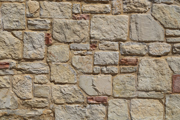 Texture of a stone wall.  House stone wall with square tiles texture background. Part of a stone fence, for background or texture