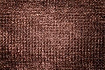 Dark brown background from soft textile material. Fabric with natural texture.