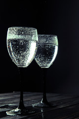 Close up, macro. Wine Glasses filled with Sparkling Drink. Isolated on black background.