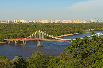Aerial landscape view of River Dnipro with Pedestrian bridge. It connects the central part of Kyiv with the park area and the beaches of Trukhanov Island. Built in 1956-1957