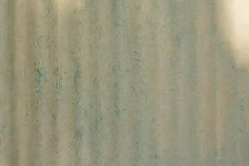 Corrugated dirty yellow-green plastic panel. Abstract grungy background with splashes.