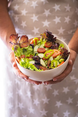 Man hands holding a green salad. Healthy lifestyle and vegetarian vegan concept.