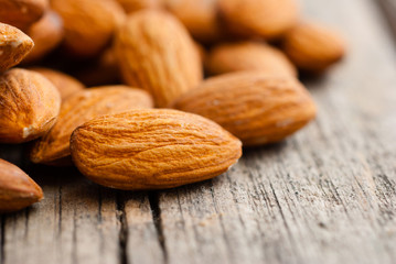peeled almonds on old wood table