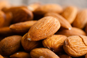 peeled almonds on old wood table