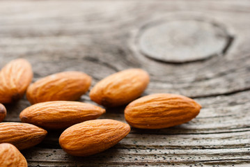 peeled almonds on old wood table