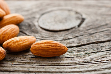 peeled almonds on old wood table