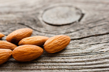 peeled almonds on old wood table
