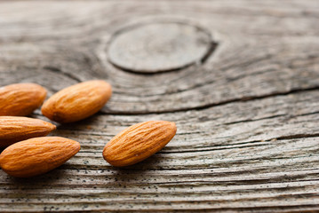 peeled almonds on old wood table
