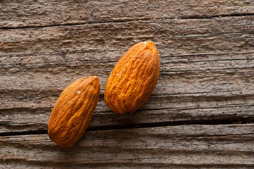 peeled almonds on old wood table