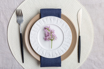 Table set with lilac branch for holiday evening