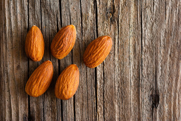 peeled almonds on old wood table