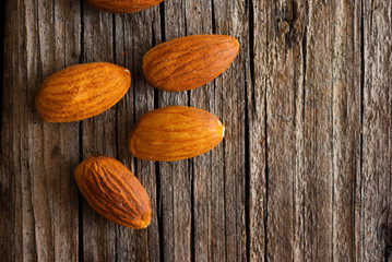 peeled almonds on old wood table