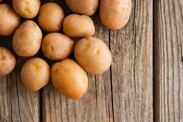 petite potatoes on rustic wood table background