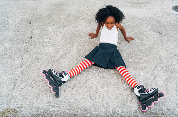 Tired female with roller skates lying on road