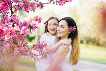 Fototapeta premium Closeup portrait of gentle gentle motherhood parenting feel satisfied am glad to have free time warm and cozy to cuddle the touch of a hand to show confidence to wear stylish white clothes in spring 