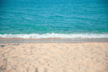 Fototapeta na wymiar Soft beautiful ocean wave on sandy beach. Background.