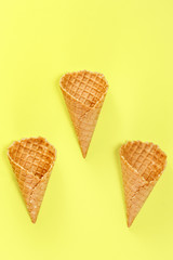 Ice cream waffle cones on Yellow Background.