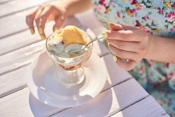a girl in the summer dress sittings on the on the open terrace cafe