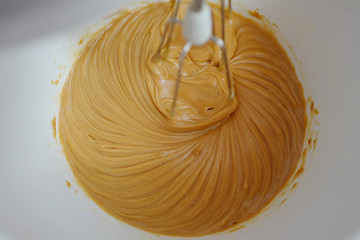 The mixer mixes cream for cake