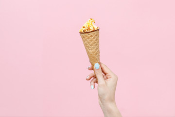Ice Cream in a waffles cone on color background.