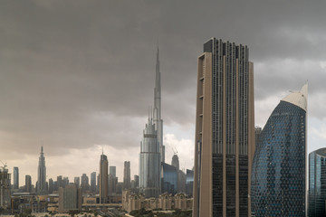 View of Burj Khalifa in Dubai Downtown with storm clouds building up over