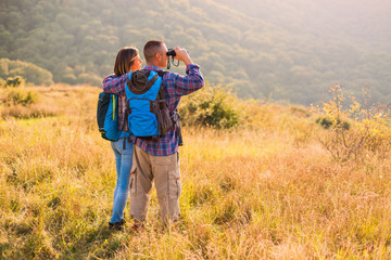 Happy couple is hiking in mountain.