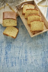 Homemade banana bread slice on a blue background.