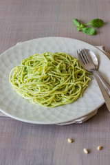Pasta with pesto sauce on a grey background. Italian cuisine. Vegetarian food. The diet.