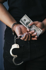 Police bribery .Police arrest drug trafficker with handcuffs. Law and police concept.