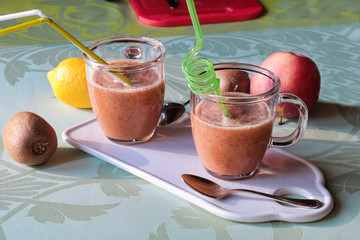 two glass of fresh fruits smoothie with drinking straw