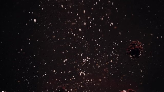 Slow motion of blackberries falling into water against black background.