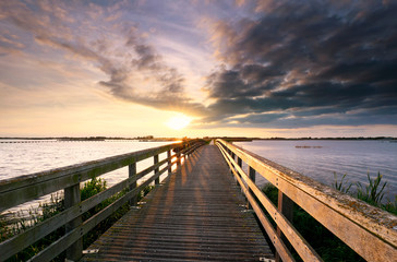 Fototapeta na wymiar evening sunshine over wooden bridge