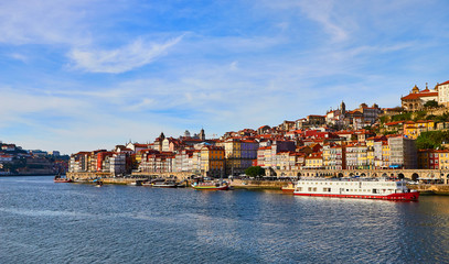 Fototapeta na wymiar Portugal, Porto old town ribeira aerial promenade view with colorful houses, Douro river and boats.Concept of world travel, sightseeing and tourism