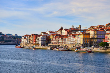 Fototapeta na wymiar Portugal, Porto old town ribeira aerial promenade view with colorful houses, Douro river and boats.Concept of world travel, sightseeing and tourism