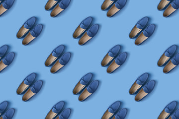 Pattern of blue suede man's mocassin shoes over blue background