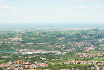 Fototapeta na wymiar Landscape on green hilly till Adriatic sea seen from the top of San Marino