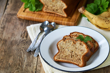 Slices of homemade banana bread in a white plate on a wooden table
