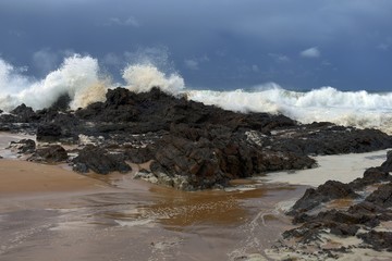 wave breaking on rocks