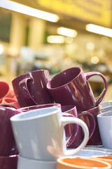 Many colorful empty ceramic cups in store, Mugs background